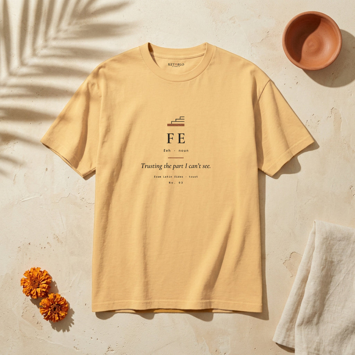 FE Palabra Tee in Faded Mustard: garment-dyed heavyweight cotton tee printed with a first step and the line “Trusting the part I can’t see.”