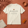 BENDICIÓN Palabra Tee in Faded Cream: garment-dyed heavyweight cotton tee printed with a wax seal stamped with a cross and the line “Mom’s goodbye, legally binding.”