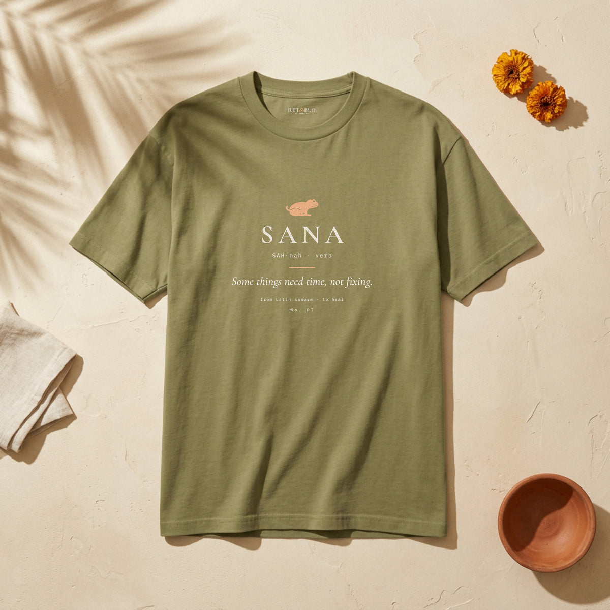 SANA Palabra Tee in Faded Army: garment-dyed heavyweight cotton tee printed with a little frog and the line “Some things need time, not fixing.”