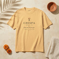 CHISPA Palabra Tee in Faded Mustard: garment-dyed heavyweight cotton tee printed with two crossed lit matches and the line “Spark. Also, what I’ve got.”