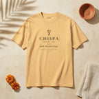 CHISPA Palabra Tee in Faded Mustard: garment-dyed heavyweight cotton tee printed with two crossed lit matches and the line “Spark. Also, what I’ve got.”