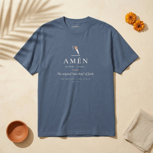AMÉN Palabra Tee in Faded Navy: garment-dyed heavyweight cotton tee printed with a falling microphone and the line “The original ‘mic drop’ of faith.”